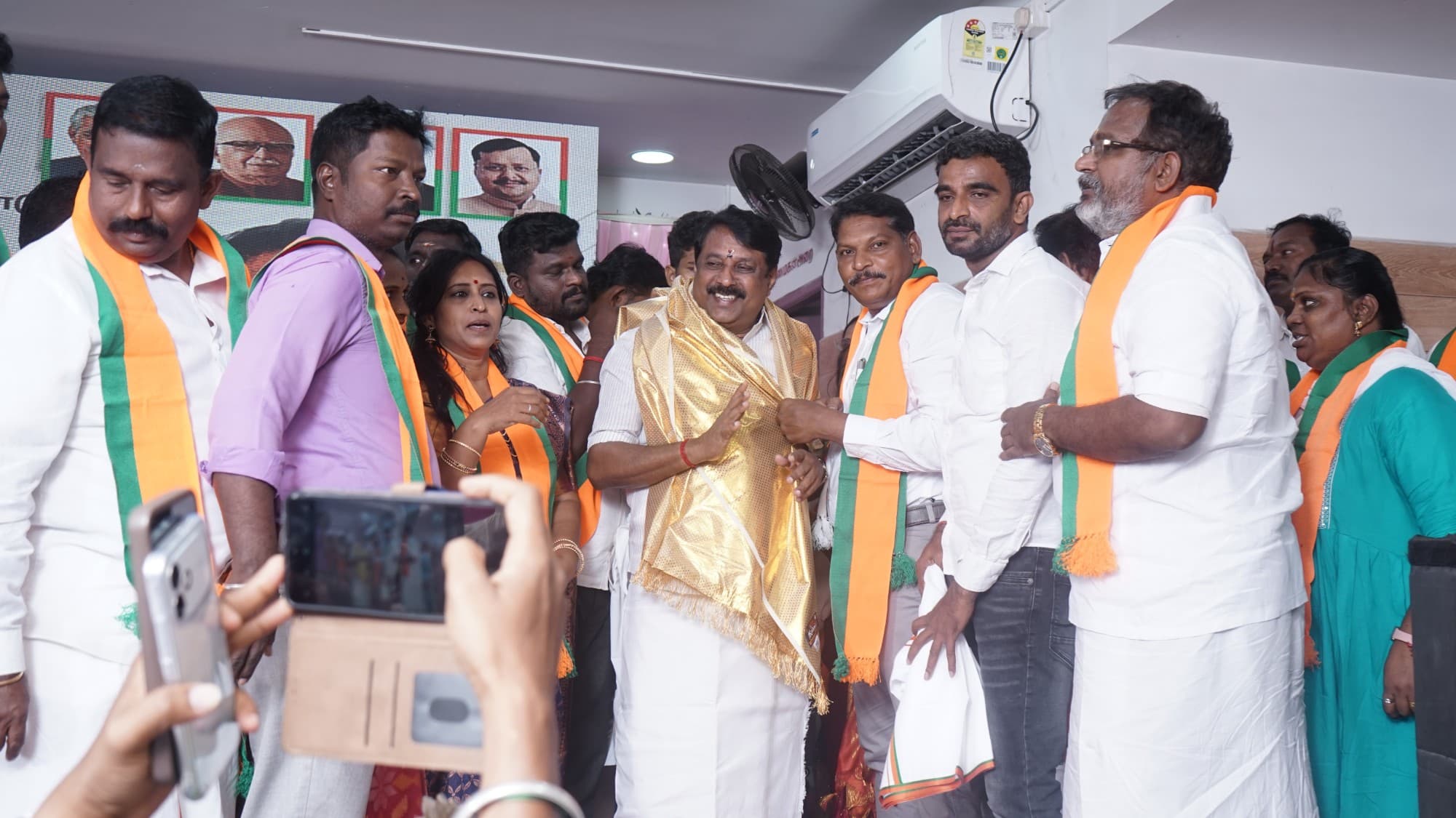 Senthilkumar greeted by BJP leaders during the joining ceremony