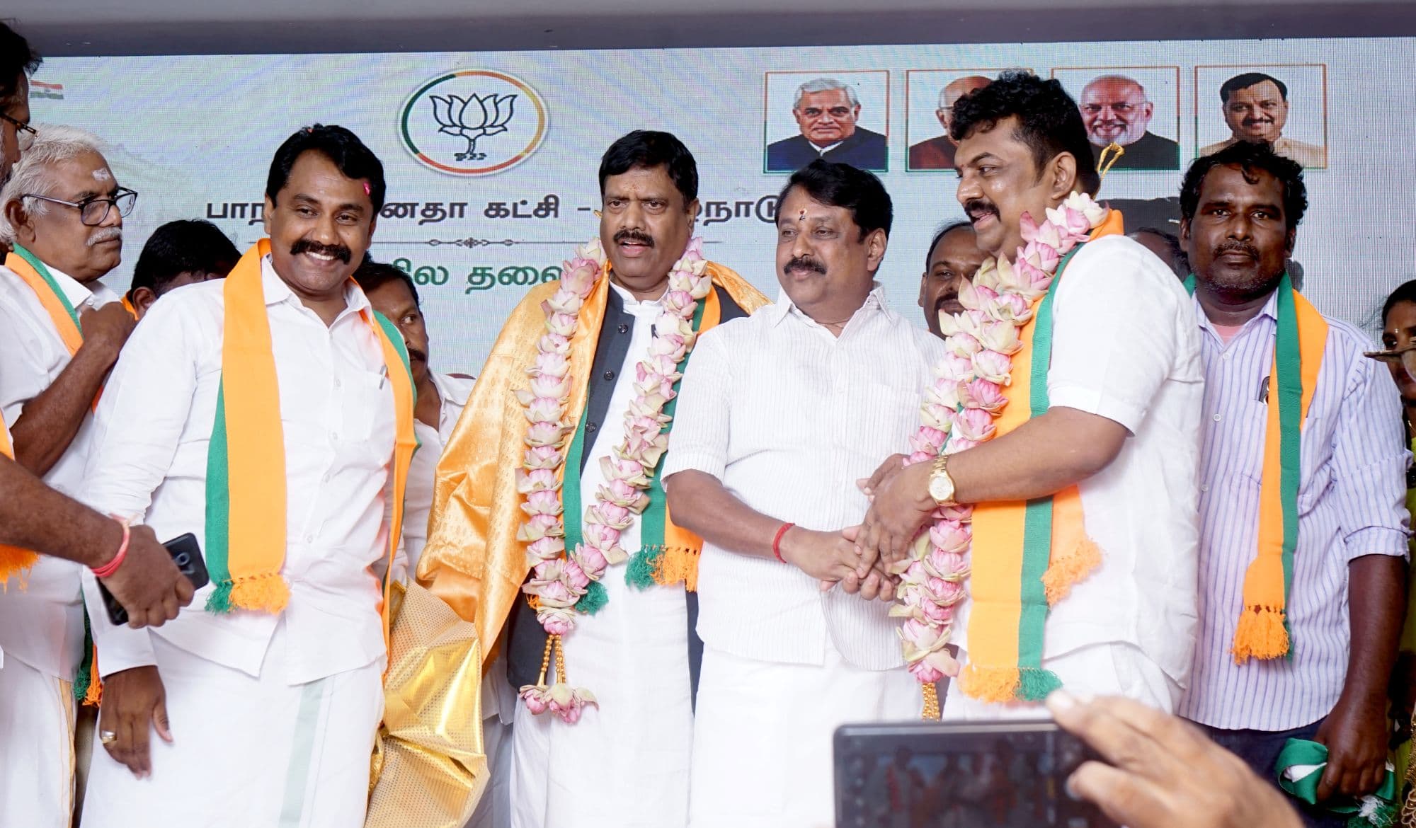 Senthilkumar with BJP leaders on stage, garlands exchanged