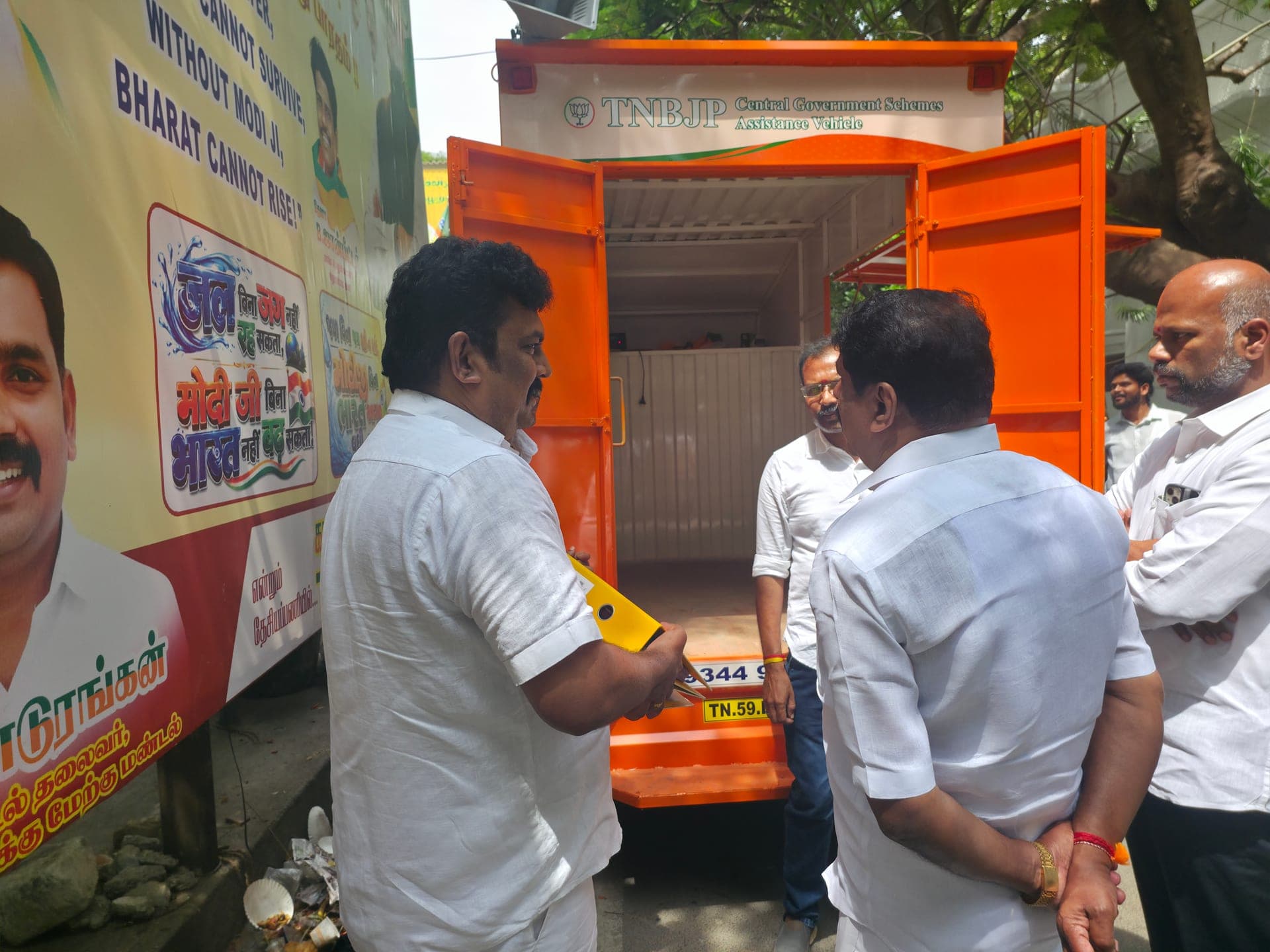 Senthilkumar Nagendran opening the SSA vehicle door at BJP HQ